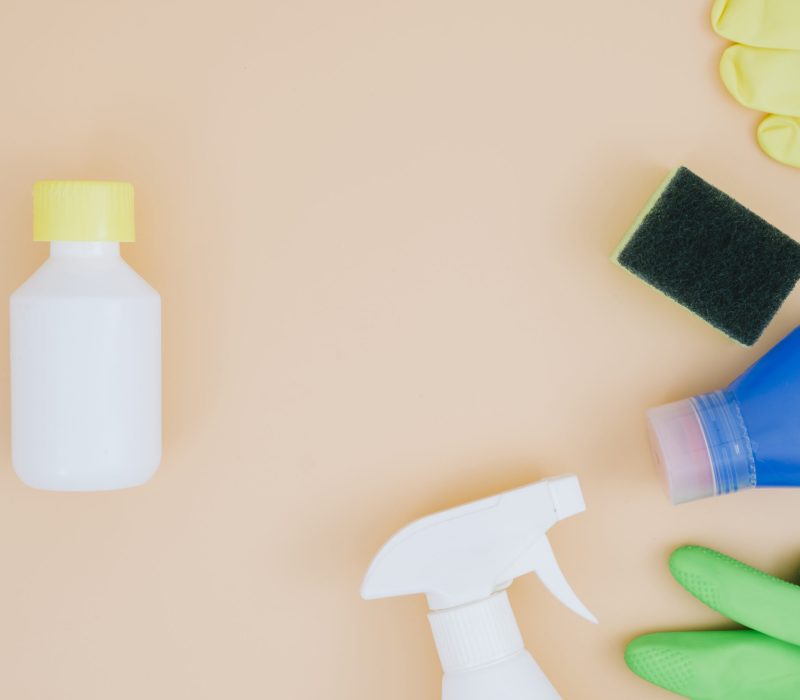 overhead-view-cleaning-supplies-peach-backdrop